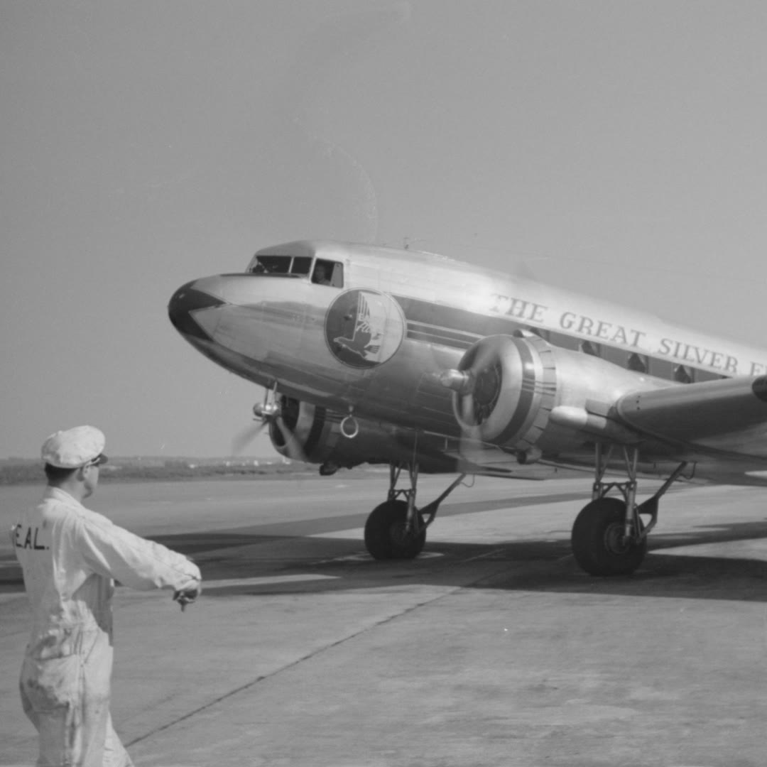 Historisches Verkehrsflugzeug mit Einweiser auf dem Vorfeld, 1941